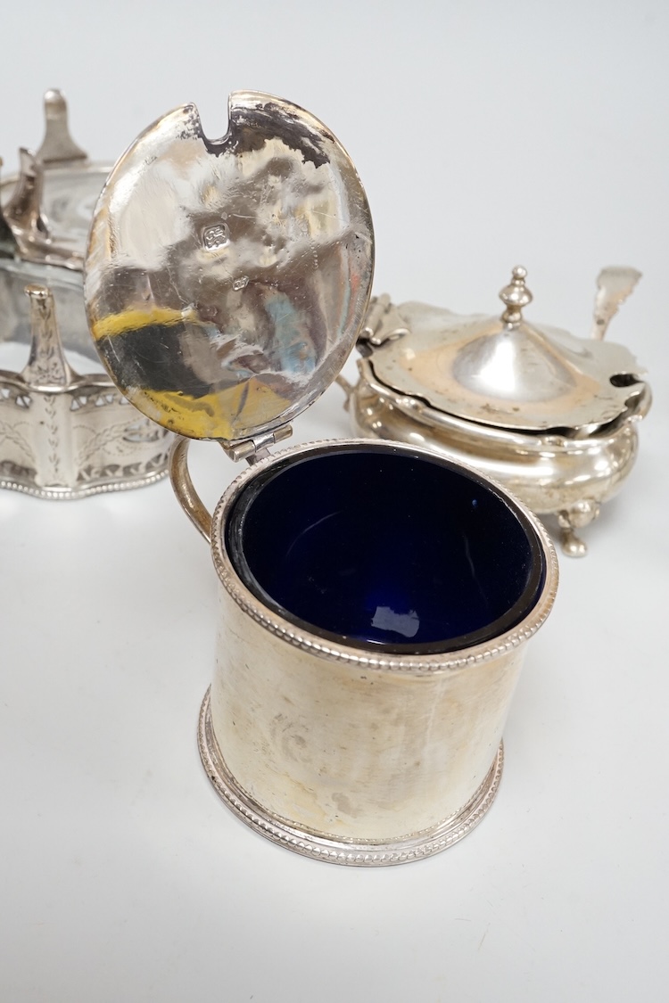 A pair of George III pierced silver shaped oval salts by Hester Bateman, London, 1783 (a.f.), with clear glass liners, together with one other George III silver oval salt, London, 1783 and two later silver mustard pots.